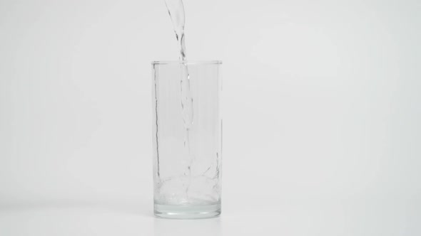 1000 Fps Shot of Pouring Water in Glass White Background