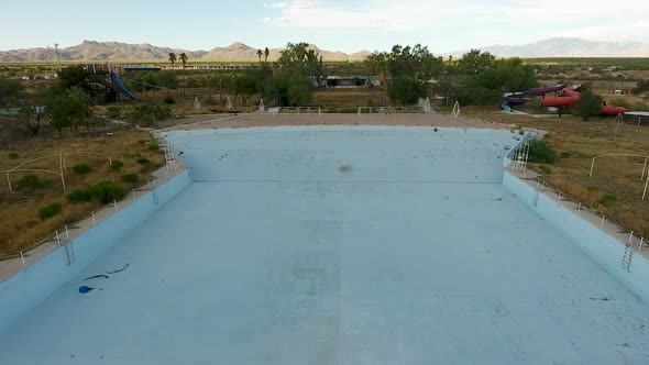 Drone shot of abandoned waterpark starting over wave pool, at Breakers in Tucson Arizona