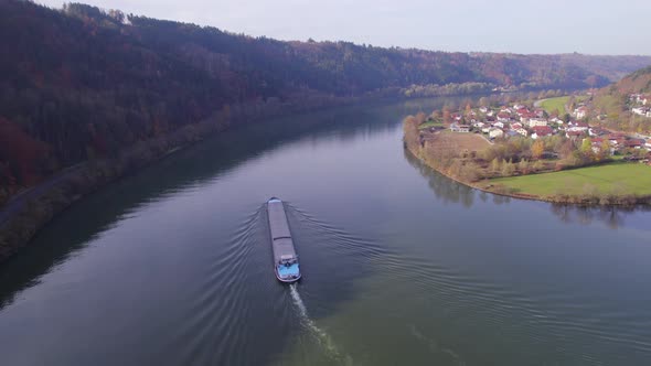 Cargo Pusher Boat on a River Transporting Cargo and Goods Along a River Bend