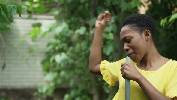 Portrait of Relaxed Joyful Gardener Singing in Watering Hose in Slow Motion Dancing in Garden