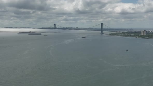 An aerial view of Gravesend Bay in Brooklyn, NY on a beautiful day with blue skies and clouds. A den