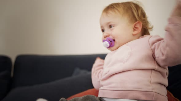 Cute baby playing at home and smiling to the camera