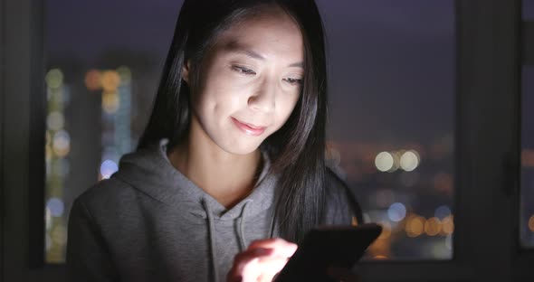 Woman look at mobile phone at home