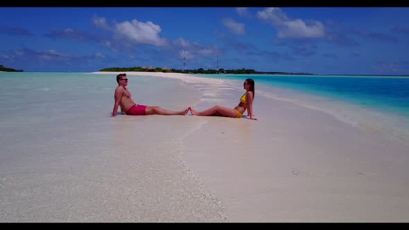 Man and lady tan on luxury island beach trip by shallow lagoon with white sand background of the Mal