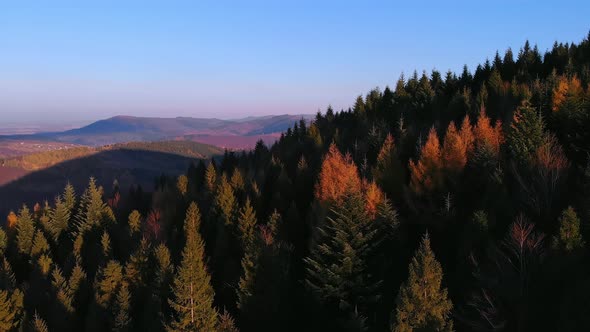 Fly above mountains in dark sunset