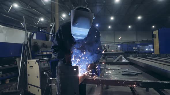 Male Welder Is Working with Metal in a Workshop. Slow Motion.