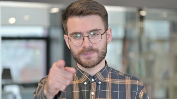 Portrait of Young Designer Pointing Finger at the Camera