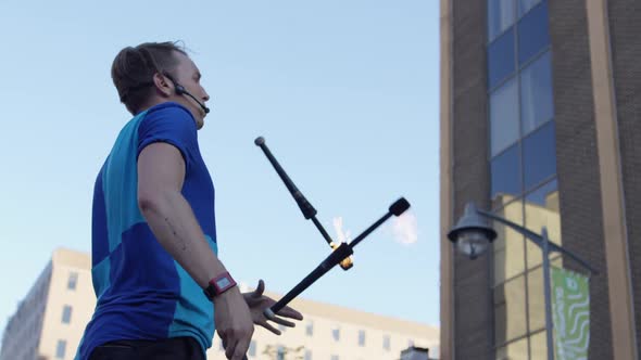 Close up slow motion juggler with fire pins