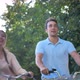 Happy Young Couple on Bicycles on a Background of Green Trees - VideoHive Item for Sale