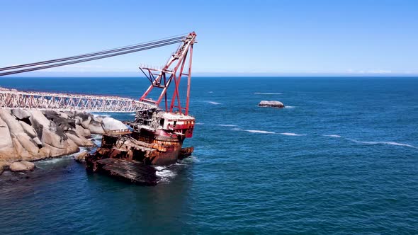 Aerial view of shipwreck crane barge is off the coast of Sandy Bay.