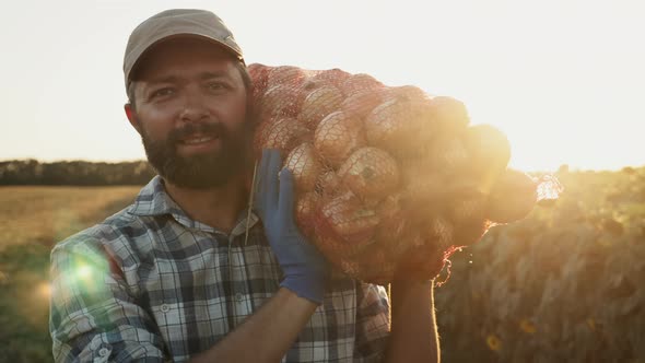 A Satisfied Farmer Carries a Bag of Onions on His Shoulder