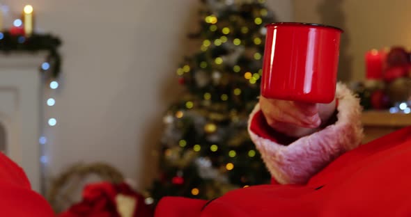 Santa claus relaxing and having coffee 4k