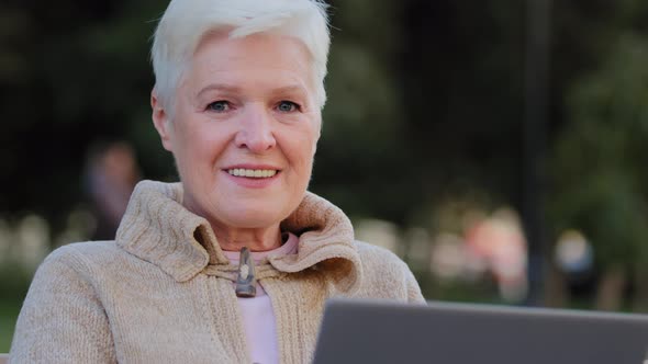 Happy Aged Woman Working at Laptop Smiling Senior Female of Retirement Age Using Computer Browsing