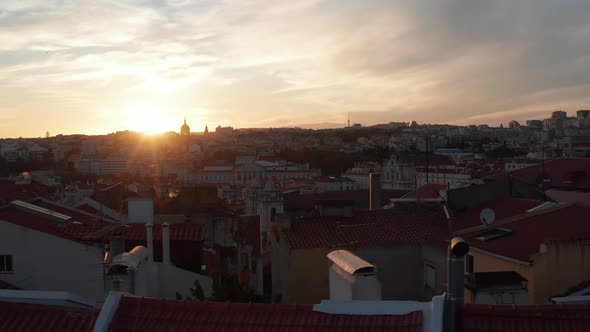 Slow Aerial Slider View of Red Rooftops with Colorful Old Houses and Churches in Urban City Center