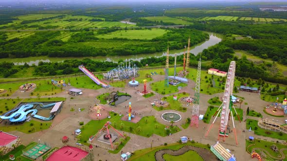 Top view of amusement park with Ferris wheel and roller coaster