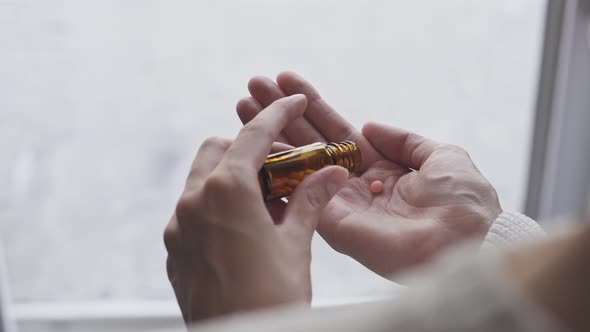 Pills In Female Hand. Woman Pours Three Pills From Glass Pill Bottle Onto Hand. Girl Takes Pill