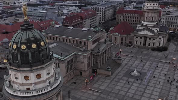 AERIAL: Slowly Passing Beautiful Old Church Over Plaza in the Center of Berlin Germany at Sunset 