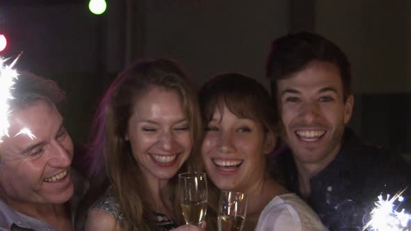 Friends celebrating with champagne and sparklers