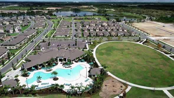 Aerial view of an upper middle class lakefront neighborhood subdivision with single family homes and