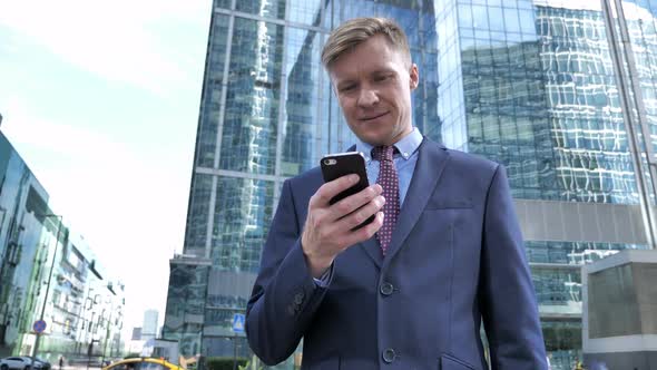 Businessman Broswing Internet on Smartphone