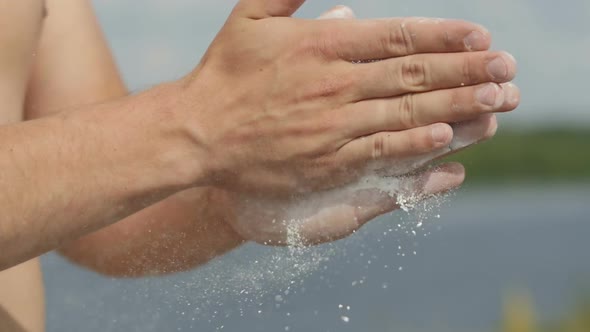 Sport Man Coating His Hands in Powder Chalk Magnesium and Preparing To Work Out