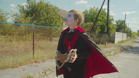 Boy in Halloween Costume Looking for Treat Outdoor