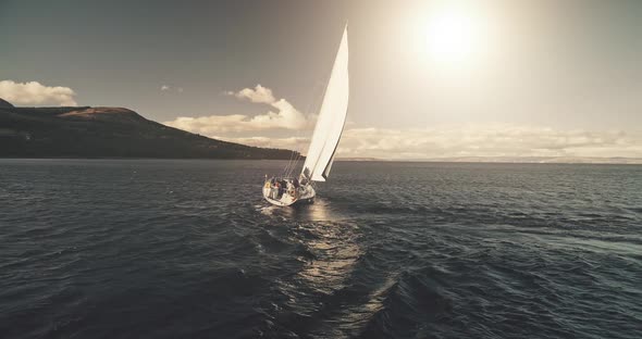 Aerial Panorama of Yacht Race in Open Sea with Sun Reflections