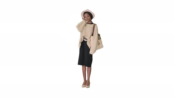 Fashionable African American Woman Posing in Knitwear and White Hat on White Background