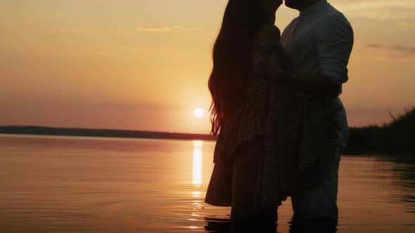 Happy Romantic Couple Enjoying Relaxing Sunset Walk on the Beach Travel Vacation Lifestyle