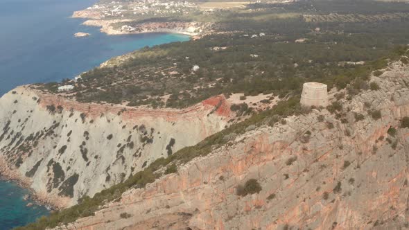 Ibiza pirate tower, aerial view over the old watch tower with the island of Ibiza in the background.