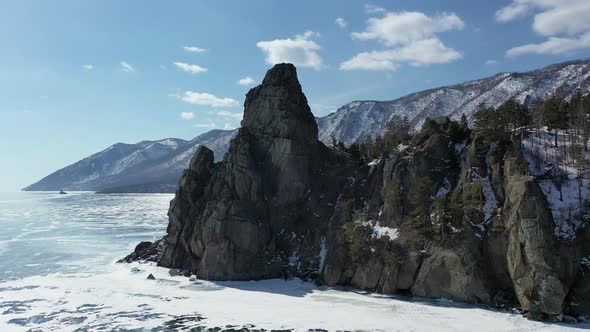 4k. Russia Baikal lake in winter from above. Flight above island and rocks. Sandy Cape