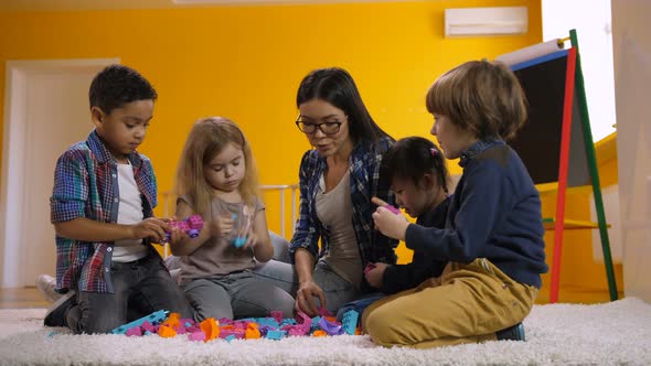 Kids Playing with Toy Blocks in Kindergarten