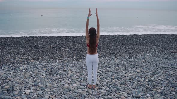 Distant Shot of a Yoga Woman on Beach.