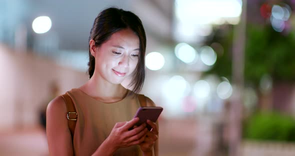 Woman use of mobile phone in the city at outdoor