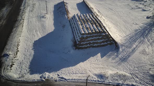 Aerial view of pile of haystacks in winter season.