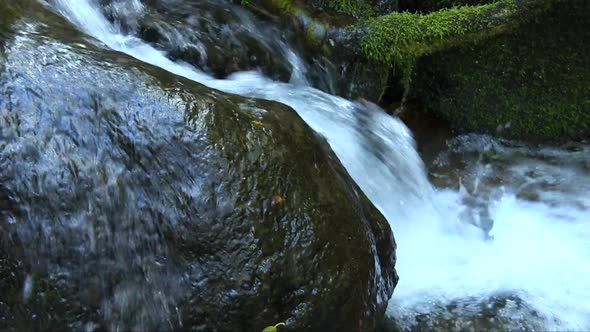 close up of water running away part of a waterfall