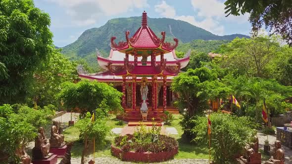 Drone Approaches To Buddhist Temple Pagoda Among Trees