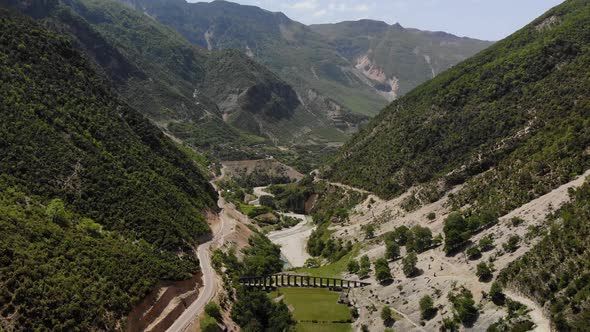 Aerial Drone Footage View Flight Over Mountain with Forests Fields and River