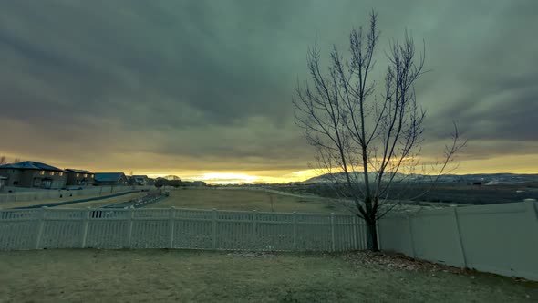 Overcast morning with a dynamic cloudscape overhead and and colorful sunrise - static wide angle tim