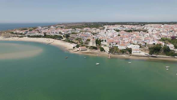 Birds eye view over coastal beach along Mira river at Vila Nova de Milfontes in Portugal. Aerial.