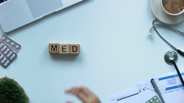 Medicine, Womans Hand Making Word of Wooden Cubes, Healthcare Reform, Top View