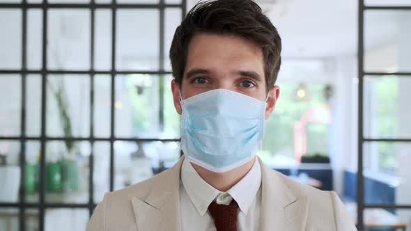 Businessman wearing protective mask in cafe