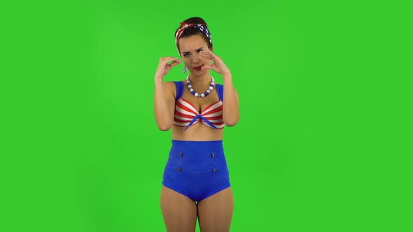 Beautiful Girl in a Swimsuit Is Posing for Camera and Making Funny Faces. Green Screen