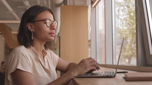 Intelligent Woman Using Computer in Cafe