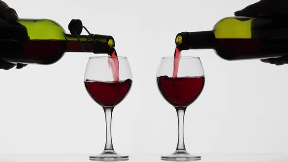 Rose Wine. Red Wine Pour in Two Wine Glasses Over White Background