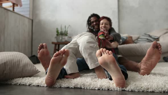 Mixed Family with Son Sitting Barefoot on Floor