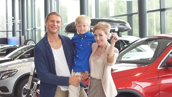 Automobile Sales Centre. Young Family with Child Boy in Car Selling Club