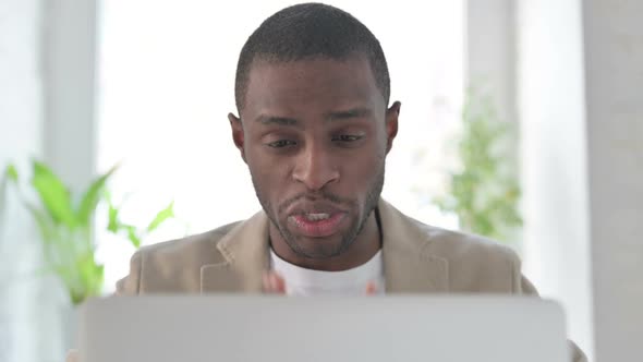 Close Up of African Man Talking on Video Call on Laptop