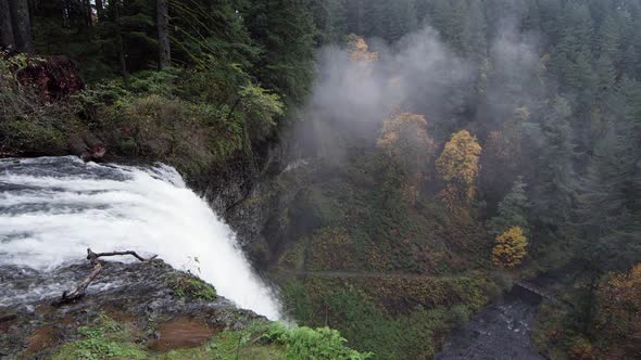 Top of a waterfall looking down towards forest below