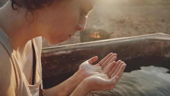 Dystopian Woman Washing Face and Resting in Dirty Bathtub